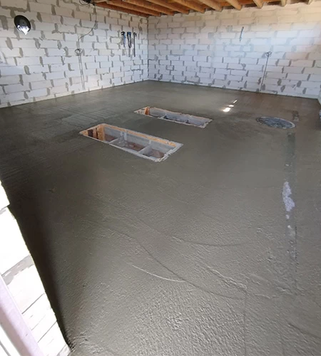Pouring the concrete floor around the installation pits
